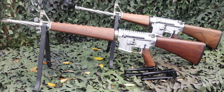 AR-15 wooden shoulder stock walnut pistol grip and hand guard in polished aluminum frame.